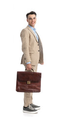 side view of happy smart casual man holding suitcase