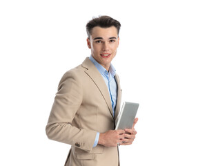 side view of attractive boy model holding tablet