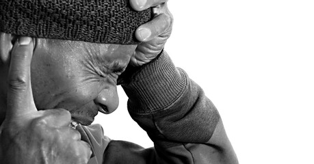 man suffering from deafness and hearing loss on grey background with people stock photo