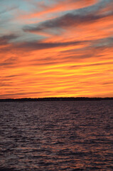 Bright Orange Sunset Landscape with Choppy Waters on the beach in Atlantic Ocean