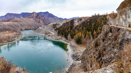 Old Chuysky tract  and bridge near the confluence of rivers Chuya & Katun in November.  Altai,...