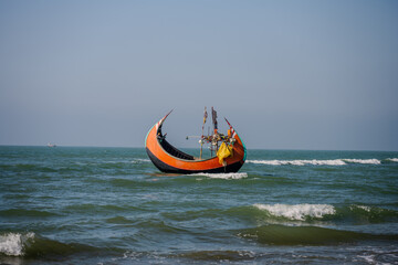 Traditional Wooden Fishing Boat on the Waves of the Bay of Bengal, Cox's Bazar, Bangladesh