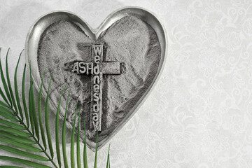 Ash Wednesday Symbol. Heart-shaped ash tray with cross and palm leaf