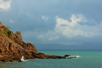 Sunbeams Through Dark Clouds Over a Serene Sea Horizon