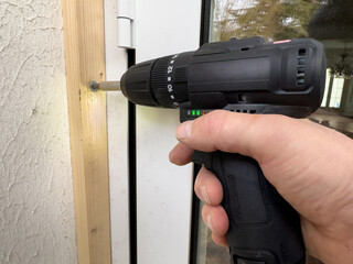 Screwdriver in action as wood is secured at a construction site