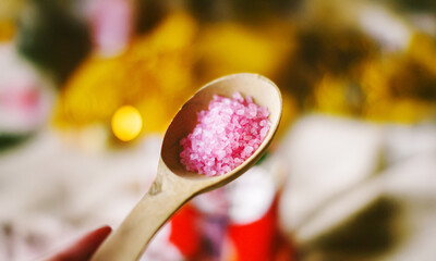 pink bath salt in a wooden spoon, natural cosmetics, hand salt, body care, women's cosmetics