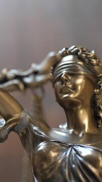 Statue of Lady Justice in lights. Scales of justice femida and law. Liberty background