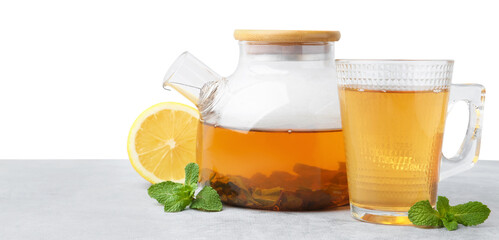 Aromatic mint tea, fresh leaves and lemon on light gray table against white background, space for text