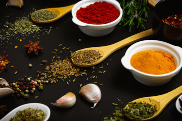 Variety of spices and herbs on kitchen table. Side view