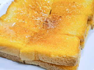 Buttered toast topped with sweetened condensed milk and sugar.