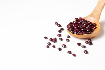 Group of red beans in a wooden spoon on white background
