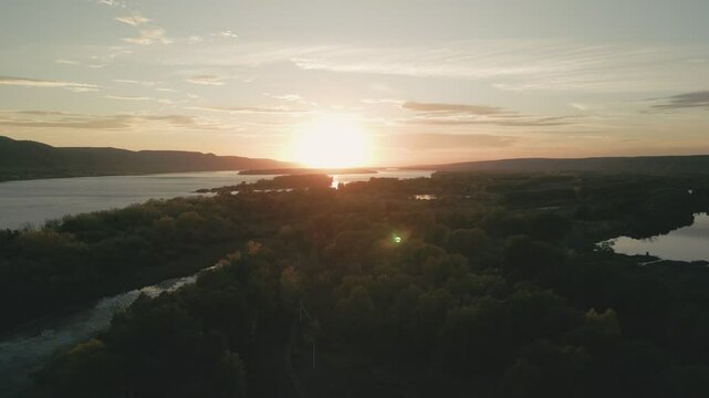 Tranquil sunset over river and forest landscape