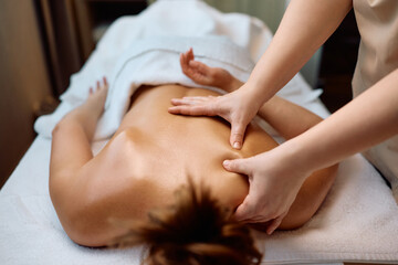 Fototapeta premium Unrecognizable woman having back massage at health spa.