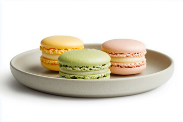 3 colorful macarons on a plate.
isolated on white background.