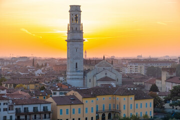 Obraz premium Aerial view of Verona old town with bell tower of Verona Cathedral, medieval architecture at sunset, Veneto, Italy. Italian cityscape. Travel destination in Europe