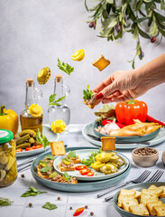 Chef preparing delicious canapes with pate and vegetables