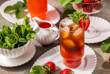 Refreshing strawberry iced tea with fresh mint and ice cubes
