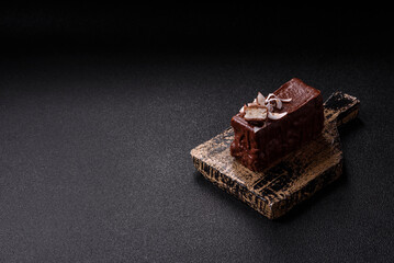 Piece of sweet chocolate bounty cake with coconut flakes and sponge