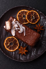 Piece of sweet chocolate bounty cake with coconut flakes and sponge