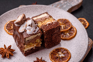 Piece of sweet chocolate bounty cake with coconut flakes and sponge