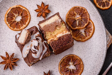 Piece of sweet chocolate bounty cake with coconut flakes and sponge