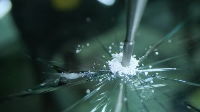 Repair of a chip in a car glass. Drills the chip with a drill