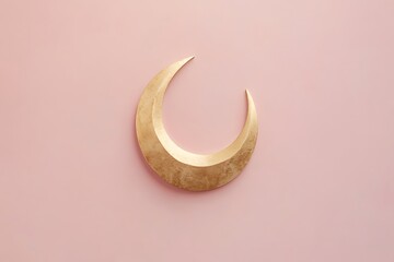A golden crescent moon on a pink background