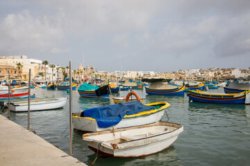 Obraz premium Fishers boats moored in Marsaxlokk bay on Malta