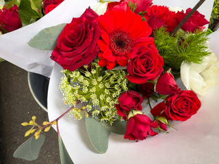 Vibrant bouquet of red roses and green accents for a special occasion