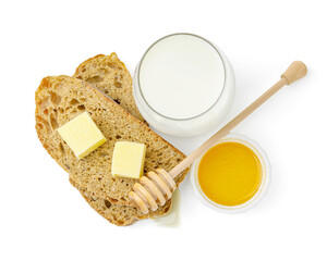 Slices of bread with butter, milk and honey isolated on white, top view