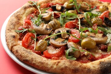 Tasty pizza with mushrooms, olives and arugula on red background, closeup