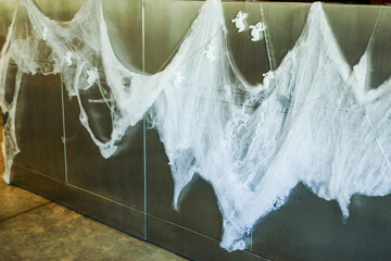 Interior of living room decorated for Halloween Pumkin,spider web,with sofa, armchair and ghosts in...