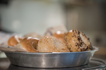 Assortment of bagels in silver plate at Rosenbergs Bagels and Delicatessen in the Five Points Historic Cultural District neighborhood.of Denver, Colorado.