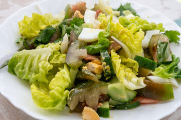 Green healthy salad with green romaine lettuce, kumato tomatoes, eggs and cucumbers