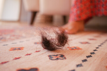 Hair clump on the floor of a cozy living room