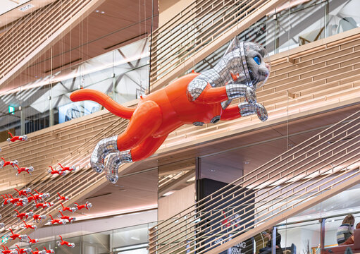 ginza, tokyo - may 14 2024: Striking inflatable sculpture 'Big Cat Bang' by Kenji Yanobe featuring a cat figure that appears to leap into the air in the Ginza Six atrium, a luxury shopping center.