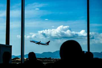 Airplane take off - view from the waiting room (terminal) at the airport (interior). Palma de Mallorca International Airport, Balearic Islands, Spain. © Kajdowy