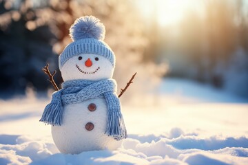 Fototapeta premium Snowman with blue knitted hat and scarf standing in a beautiful snowy winter wonderland at sunset