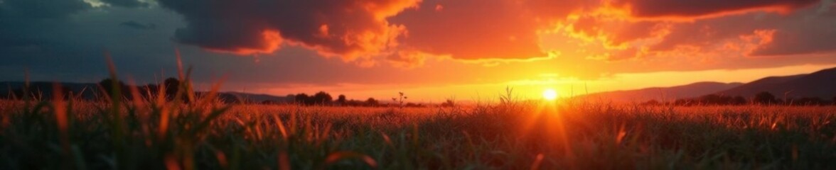 Fototapeta premium Softly glowing embers fall from the sky onto a grassy meadow at sunset, flames, wind