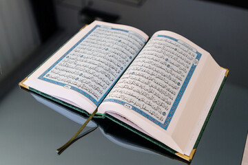 Open Quran Book Featuring Arabic Script With Blue Decorative Details. Ramadan