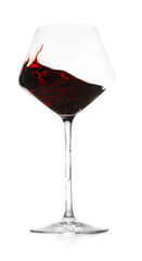 Red wine splashing in glass on white background