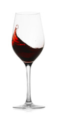 Red wine splashing in glass on white background