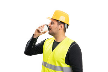 Male builder wearing work clothing drinking coffee from cup