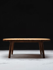 Modern round wooden table on a minimalist backdrop with a dark background showcasing its design and craftsmanship