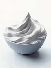 Creamy whipped topping beautifully swirled in a white bowl on a neutral background