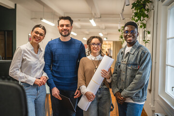 Portrait of business workers colleagues stand and smile in the office