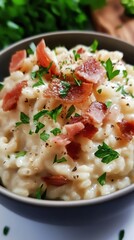 Creamy parmesan risotto with crispy bacon and fresh parsley garnish