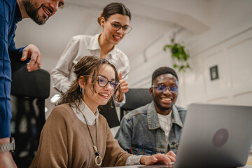 Fototapeta premium multicultural colleagues work together on laptop in the office