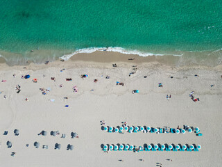 Travel to sea. Aerial top view of sand beach with crystal clear turquoise water. Summer vacation in paradise. Beach vacation at sea in summer. Sea relax under beach umbrella. Maldives turquoise water