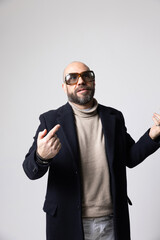 Fototapeta premium Stylish mature bald man with beard, posing confidently indoors. Vertial.